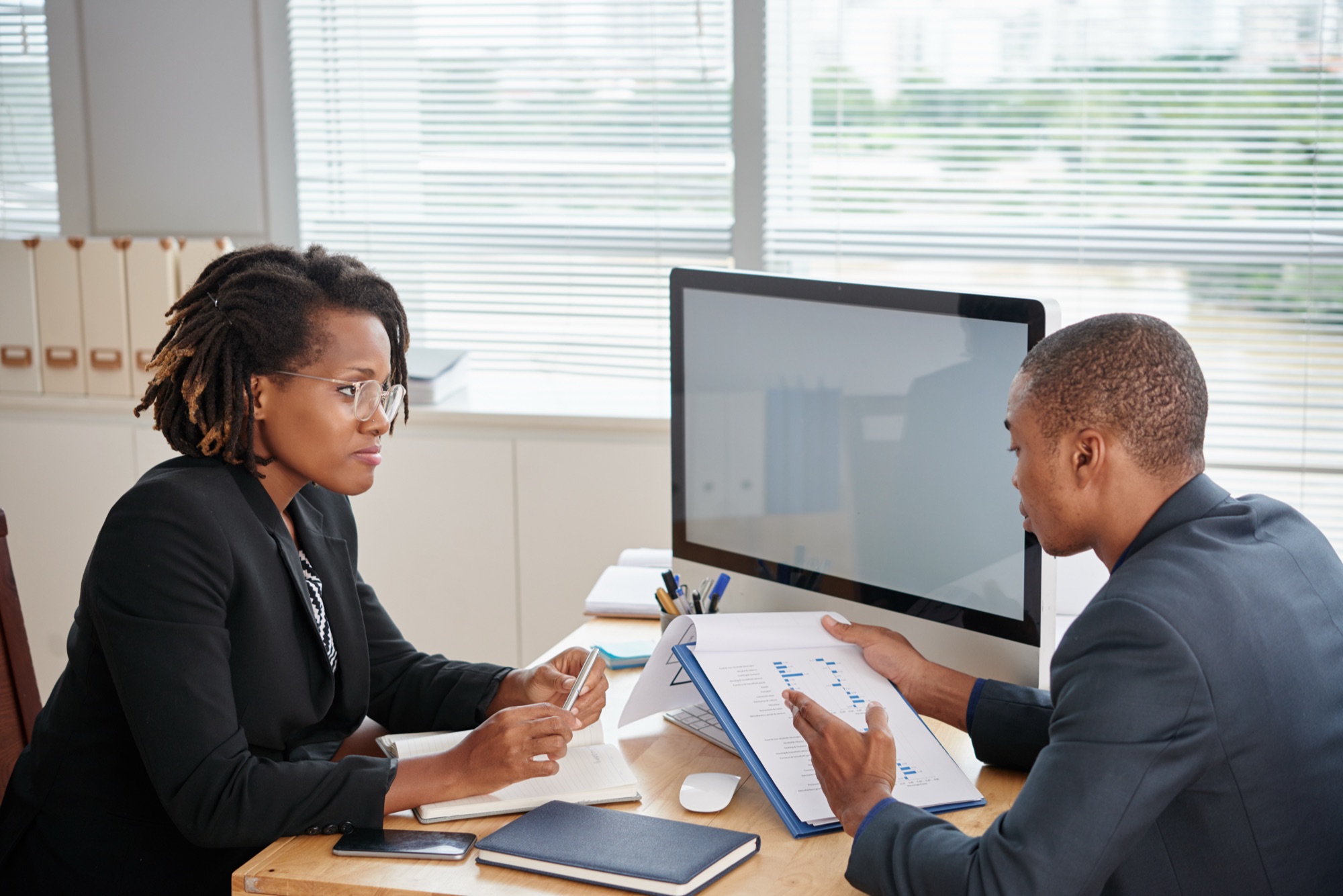 An iPRO Botswana adviser discussing a portfolio with a client